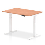 Height adjustable office desk with white frame and USB power ports